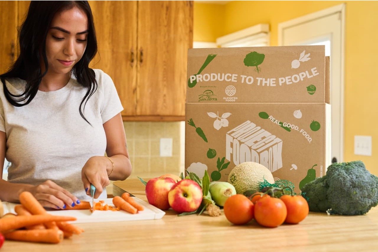 woman preparing a meal using ingredients from a Project FoodBox package