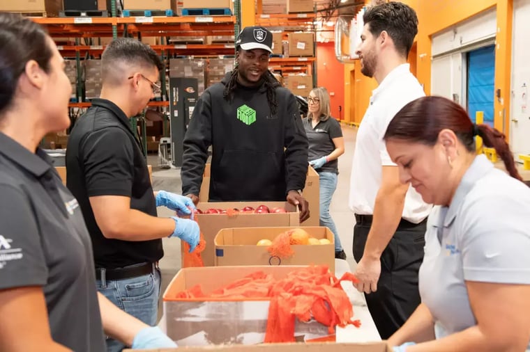 Wide receiver Davante Adams helps sort produce at a local food bank in Las Vegas
