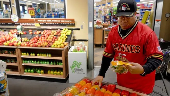retired US Marine shops for fruits and vegetables as part of a food as medicine program