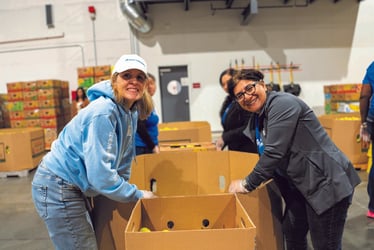 Kaiser Permanente staff, including Regional President Cynthia Dold (left), volunteer at Food Lifeline in Seattle